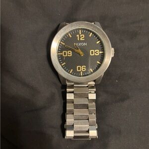 Nixon Silver Watch with Black and Gold Accents